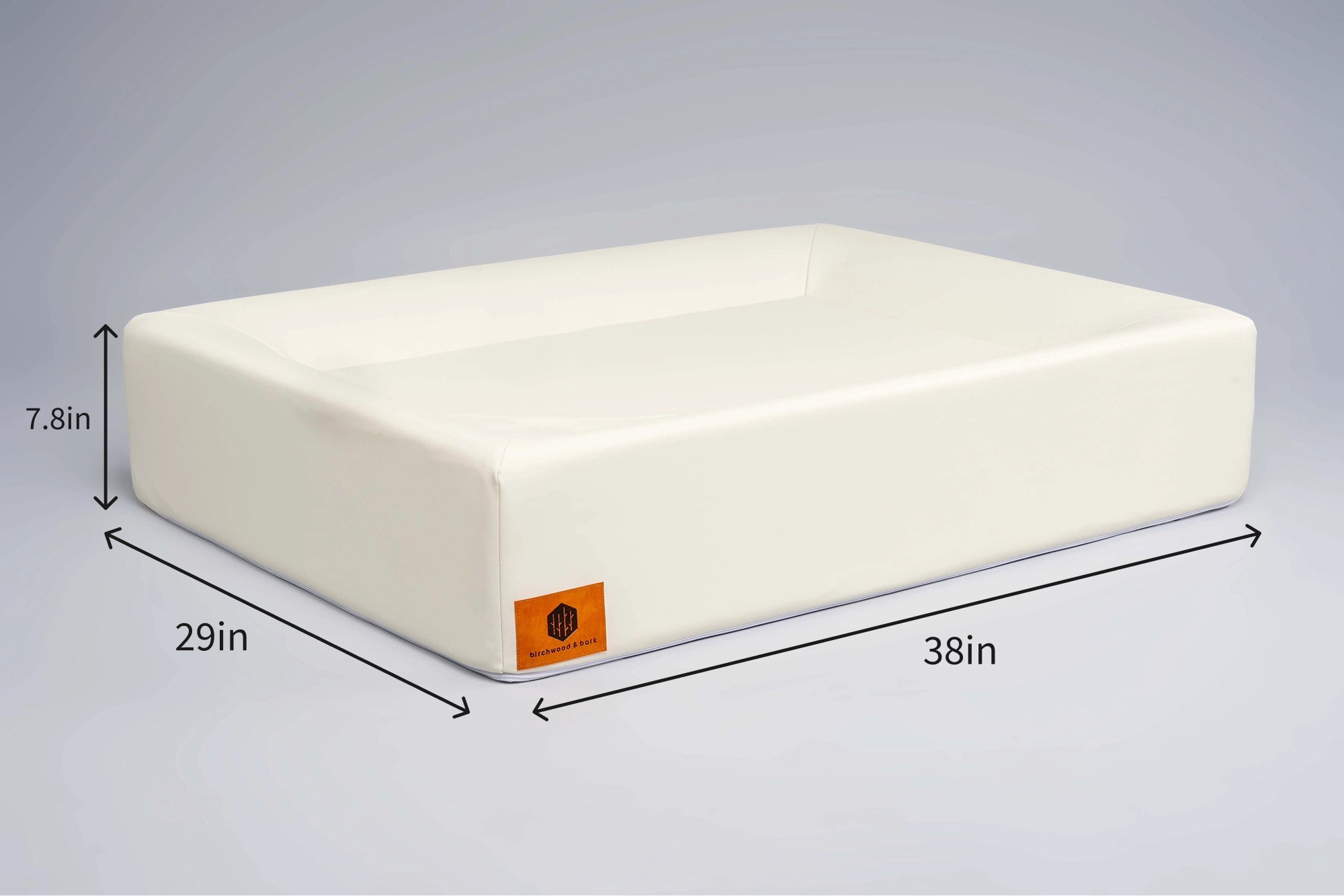 Large brown dog lounging on cream Birchwood & Bark laundry-free, sustainable dog bed